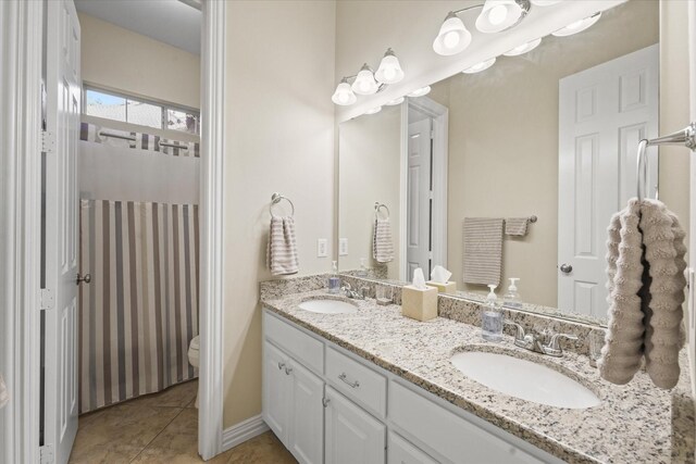 3102 Hidden Springs Dr, Corinth, TX 76210 - full bathroom with double vanity and tile patterned floors