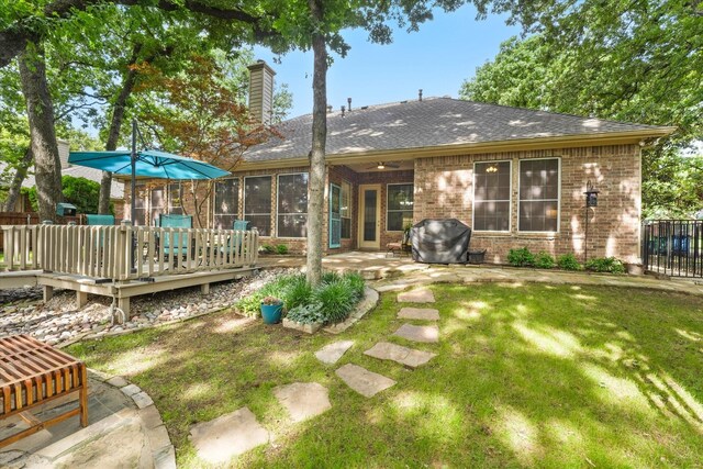 3102 Hidden Springs Dr, Corinth, TX 76210 - back of house with brick siding, a chimney, a wooden deck, a shingled roof, and a patio