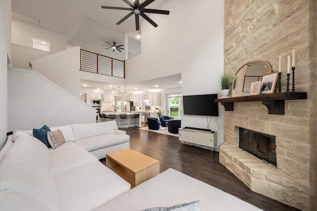 3603 High Dr, Grapevine, TX 76051 - living area featuring a ceiling fan, dark wood finished floors, a stone fireplace, a high ceiling, and stairway