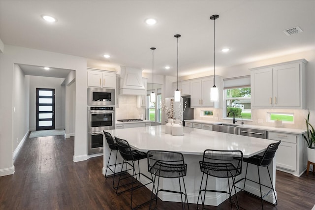 3603 High Dr, Grapevine, TX 76051 - kitchen with stainless steel appliances, a breakfast bar, tasteful backsplash, light countertops, and white cabinetry