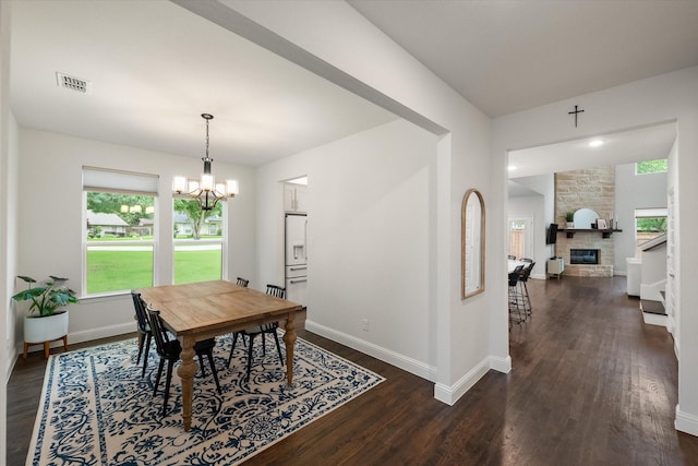 3603 High Dr, Grapevine, TX 76051 - dining area featuring dark wood-type flooring, a chandelier, and a fireplace