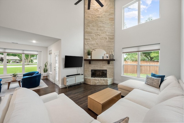 3603 High Dr, Grapevine, TX 76051 - living area featuring a high ceiling, dark wood-style floors, healthy amount of natural light, ceiling fan, and a stone fireplace