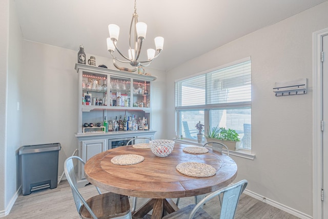 656 Bunk House Dr, Venus, TX 76084 - dining area featuring light wood-style flooring, a chandelier, and a dry bar