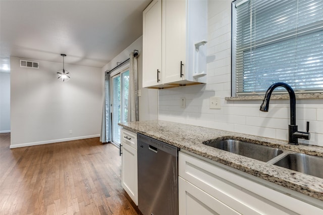 3641 La Prada Dr, Mesquite, TX 75150 - kitchen with stainless steel dishwasher, tasteful backsplash, white cabinets, hardwood / wood-style floors, and light stone counters