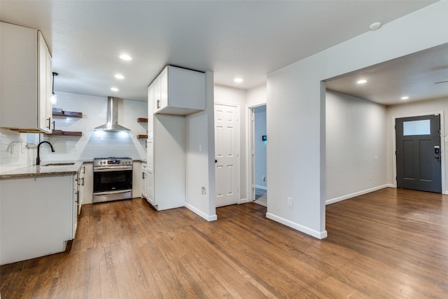 3641 La Prada Dr, Mesquite, TX 75150 - kitchen featuring stainless steel gas range, wall chimney range hood, dark wood-type flooring, open shelves, and white cabinets