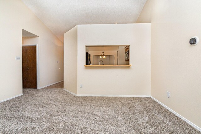 2114 Norway Dr, Garland, TX 75040 - unfurnished living room with carpet, lofted ceiling, and a textured ceiling