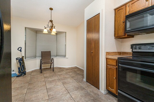 2114 Norway Dr, Garland, TX 75040 - kitchen with black appliances, brown cabinets, decorative light fixtures, lofted ceiling, and light countertops