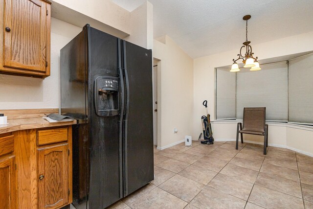 2114 Norway Dr, Garland, TX 75040 - kitchen featuring black refrigerator with ice dispenser, light tile patterned flooring, butcher block counters, pendant lighting, and a chandelier