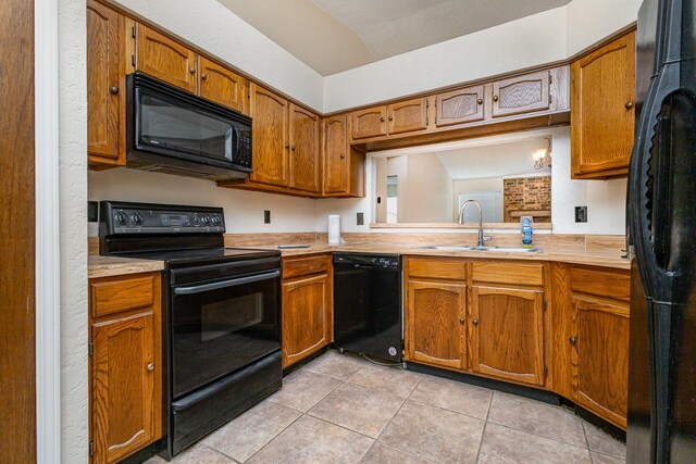 2114 Norway Dr, Garland, TX 75040 - kitchen with black appliances, light countertops, light tile patterned flooring, brown cabinets, and vaulted ceiling
