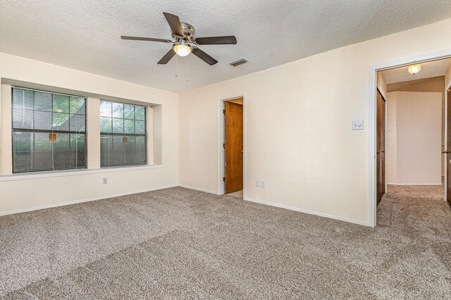2114 Norway Dr, Garland, TX 75040 - carpeted empty room with a ceiling fan and a textured ceiling