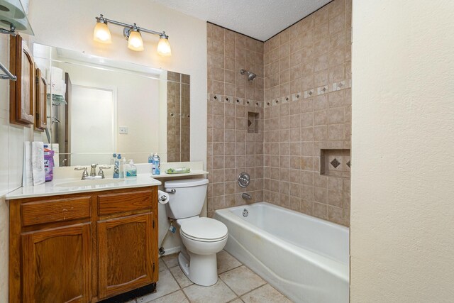 2114 Norway Dr, Garland, TX 75040 - bathroom with tile patterned floors, vanity, bathtub / shower combination, and a textured ceiling