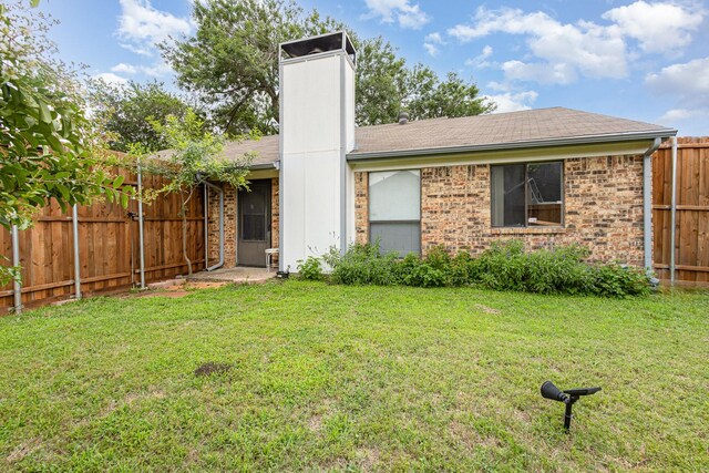 2114 Norway Dr, Garland, TX 75040 - back of property featuring brick siding, roof with shingles, and a chimney