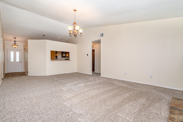 2114 Norway Dr, Garland, TX 75040 - unfurnished living room with lofted ceiling, carpet flooring, a chandelier, and a textured ceiling