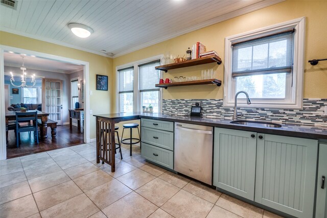 6201 Reiger Ave, Dallas, TX 75214 - kitchen featuring dishwasher, dark countertops, a chandelier, tasteful backsplash, and crown molding