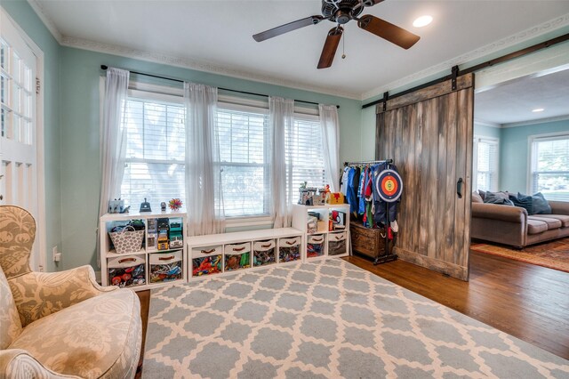 6201 Reiger Ave, Dallas, TX 75214 - recreation room with wood finished floors, crown molding, a ceiling fan, a barn door, and recessed lighting