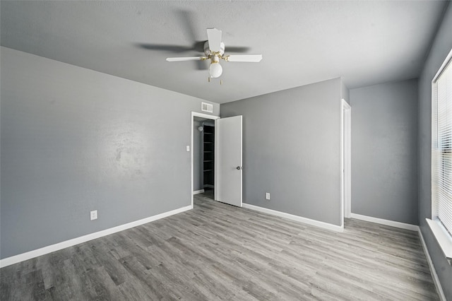 2415 Sunflower Dr, Arlington, TX 76014 - unfurnished bedroom featuring wood finished floors and a ceiling fan