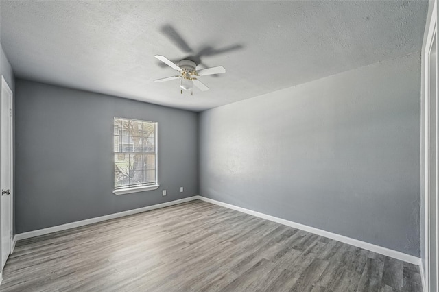 2415 Sunflower Dr, Arlington, TX 76014 - unfurnished room with wood finished floors, a ceiling fan, and a textured ceiling