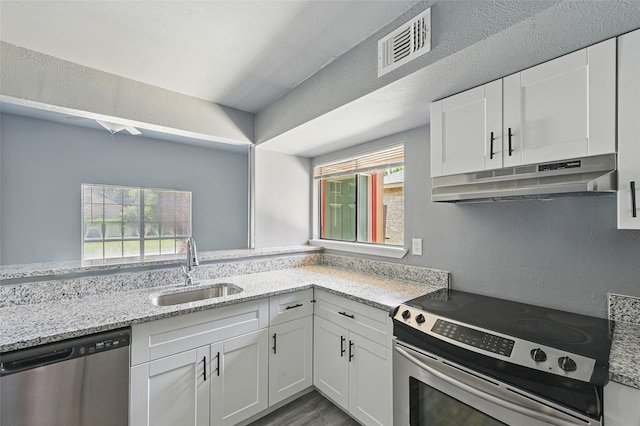 2415 Sunflower Dr, Arlington, TX 76014 - kitchen featuring appliances with stainless steel finishes, under cabinet range hood, white cabinetry, and light stone counters