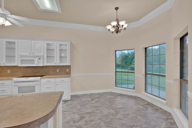 9841 Freedoms Way, Keithville, LA 71047 - kitchen with white appliances, crown molding, light countertops, a chandelier, and white cabinets
