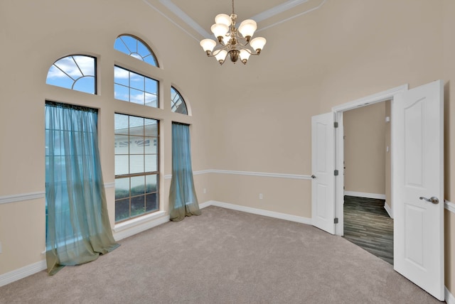 9841 Freedoms Way, Keithville, LA 71047 - spare room featuring a chandelier, carpet flooring, ornamental molding, and a high ceiling