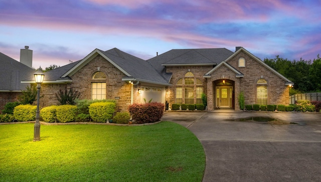 9841 Freedoms Way, Keithville, LA 71047 - view of front of property with brick siding, driveway, a yard, and an attached garage