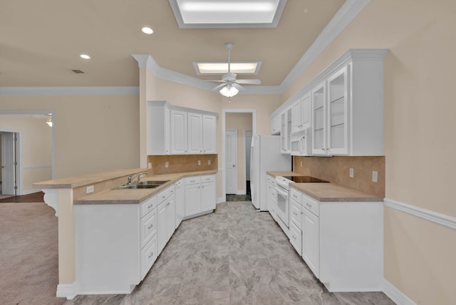 9841 Freedoms Way, Keithville, LA 71047 - kitchen with white appliances, a peninsula, white cabinetry, crown molding, and tasteful backsplash