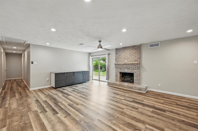 8434 Sweetwood Dr, Dallas, TX 75228 - unfurnished living room featuring ceiling fan, wood finished floors, recessed lighting, a fireplace, and attic access