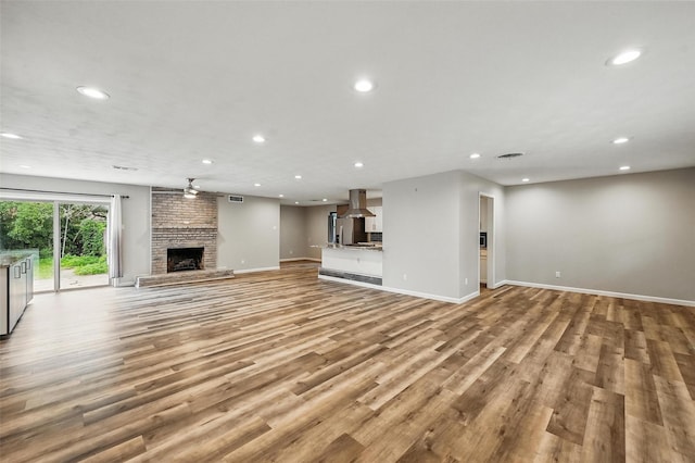 8434 Sweetwood Dr, Dallas, TX 75228 - unfurnished living room with recessed lighting, a brick fireplace, and light wood-style flooring