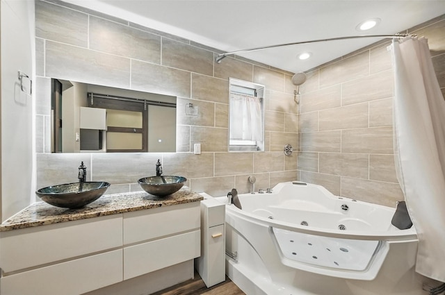 8434 Sweetwood Dr, Dallas, TX 75228 - full bath with tile walls, a combined bath / shower with jetted tub, backsplash, double vanity, and recessed lighting