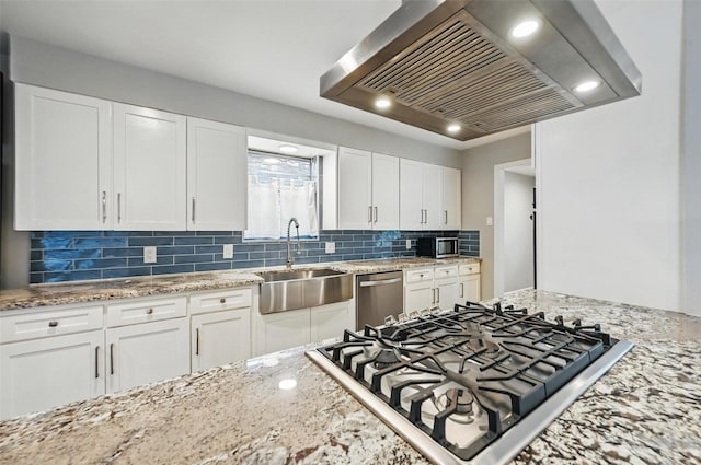 8434 Sweetwood Dr, Dallas, TX 75228 - kitchen with stainless steel appliances, island range hood, white cabinets, decorative backsplash, and recessed lighting