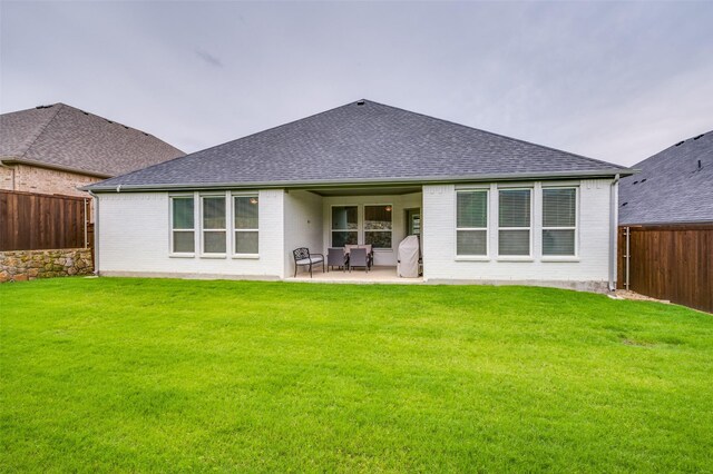 309 Savannah Ln, Oak Point, TX 75068 - back of house featuring a fenced backyard, brick siding, a shingled roof, and a patio area