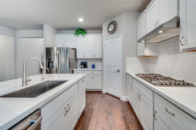 309 Savannah Ln, Oak Point, TX 75068 - kitchen featuring stainless steel appliances, under cabinet range hood, tasteful backsplash, white cabinetry, and dark wood-style flooring