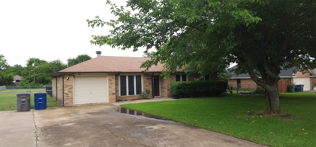 414 Butterfly Ln, Red Oak, TX 75154 - single story home with concrete driveway, an attached garage, and brick siding