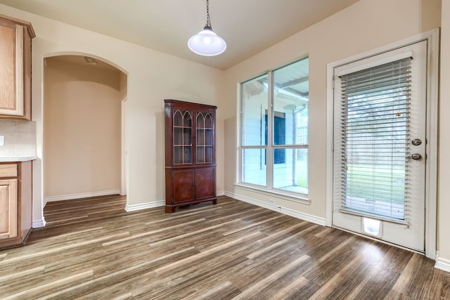 3003 Margot Ct, Wylie, TX 75098 - unfurnished dining area with wood finished floors and arched walkways