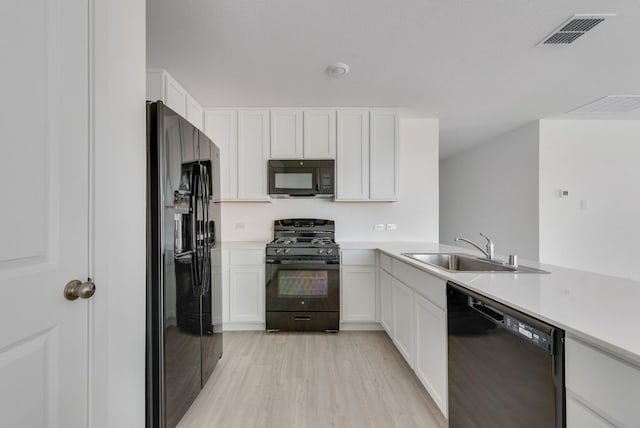 1961 Kiwi Dr, Royse City, TX 75189 - kitchen featuring black appliances, light countertops, and white cabinets