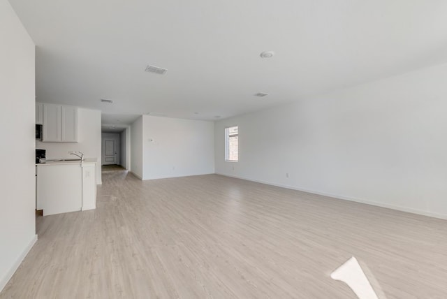 1961 Kiwi Dr, Royse City, TX 75189 - unfurnished living room with light wood-style floors and baseboards