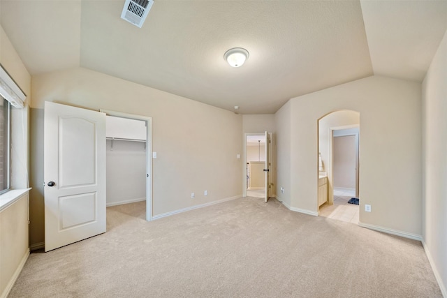 5048 Exposition Way, Fort Worth, TX 76244 - unfurnished bedroom with lofted ceiling, light colored carpet, a walk in closet, ensuite bathroom, and a closet