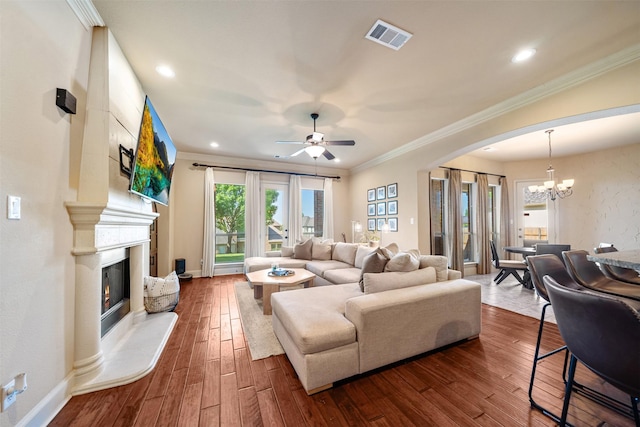 5048 Exposition Way, Fort Worth, TX 76244 - living room featuring a chandelier, a premium fireplace, arched walkways, ornamental molding, and ceiling fan