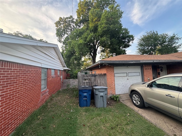 2643 Hillsboro Ave, Dallas, TX 75228 - view of property exterior featuring brick siding, a garage, and concrete driveway