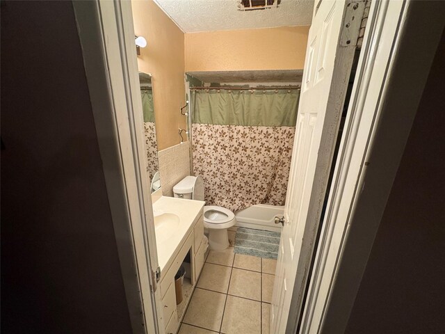 2643 Hillsboro Ave, Dallas, TX 75228 - full bath with tile patterned floors, a textured ceiling, vanity, tile walls, and a shower with curtain