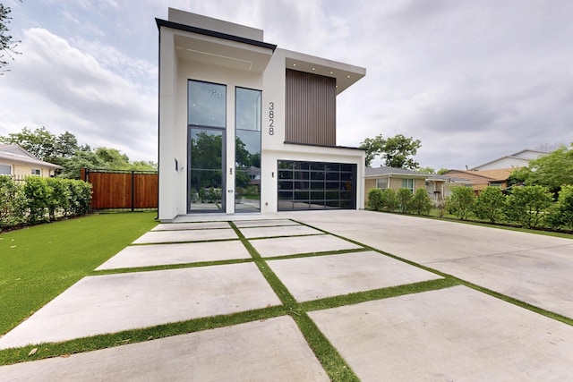 3828 Eaton Dr, Dallas, TX 75220 - contemporary home featuring driveway, a garage, and stucco siding