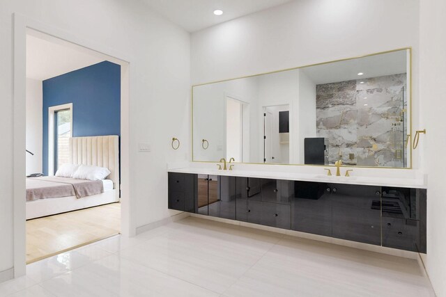 3828 Eaton Dr, Dallas, TX 75220 - bathroom featuring double vanity, ensuite bathroom, a marble finish shower, recessed lighting, and tile patterned floors