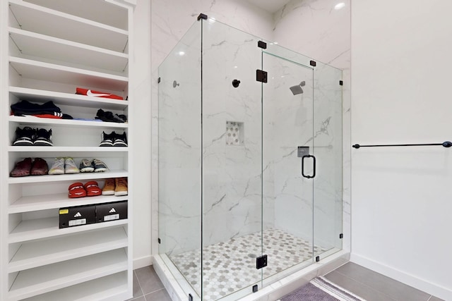 3828 Eaton Dr, Dallas, TX 75220 - bathroom featuring a marble finish shower, tile patterned floors, and a spacious closet