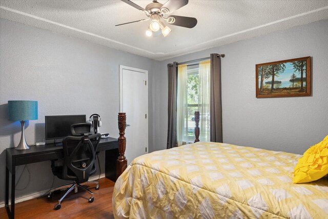 213 NE Alsbury Blvd, Burleson, TX 76028 - bedroom featuring wood finished floors, an office area, a textured ceiling, ceiling fan, and a textured wall