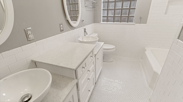 10150 Eastwood Dr, Dallas, TX 75228 - full bath featuring tile walls, vanity, a wainscoted wall, a bath, and tile patterned flooring