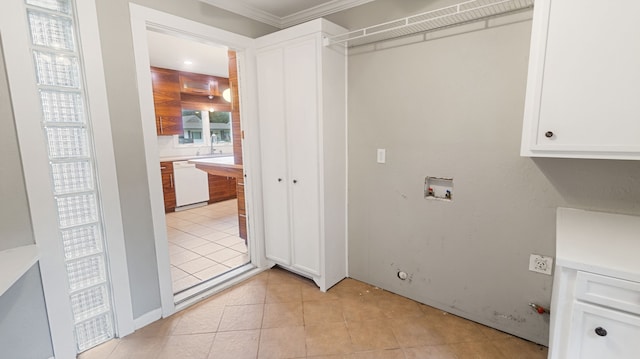 10150 Eastwood Dr, Dallas, TX 75228 - laundry area featuring hookup for a washing machine, light tile patterned floors, and ornamental molding