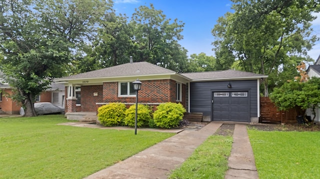 10150 Eastwood Dr, Dallas, TX 75228 - view of front of home featuring concrete driveway, an attached garage, a front yard, and brick siding