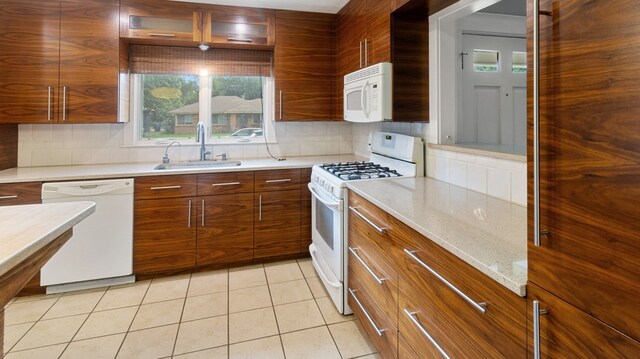 10150 Eastwood Dr, Dallas, TX 75228 - kitchen featuring white appliances, brown cabinetry, decorative backsplash, and modern cabinets