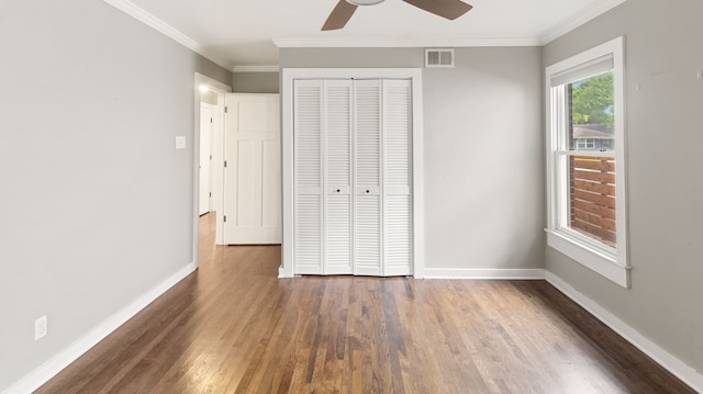 10150 Eastwood Dr, Dallas, TX 75228 - unfurnished bedroom featuring wood finished floors, crown molding, a closet, and a ceiling fan