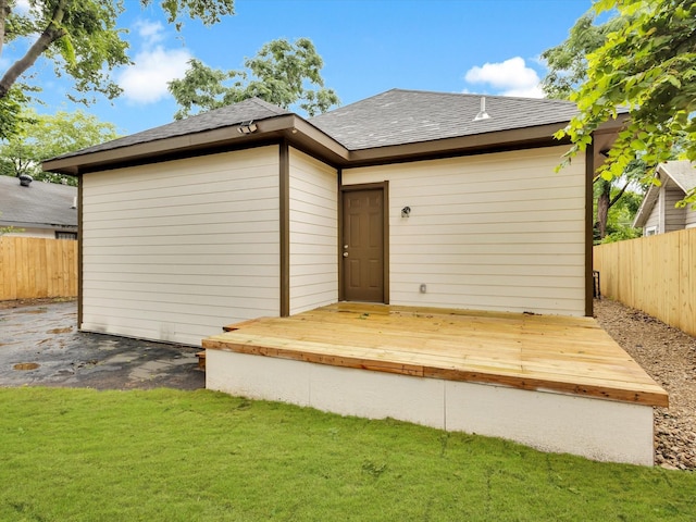 3526 Elsie Faye Heggins St, Dallas, TX 75210 - rear view of house with a fenced backyard, a shingled roof, and a wooden deck